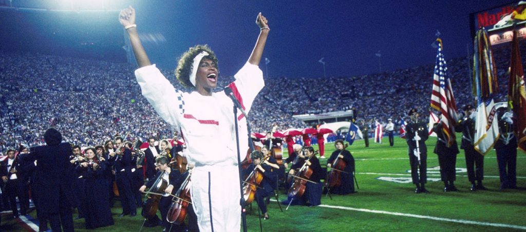 Whitney Houston sings the National Anthem.